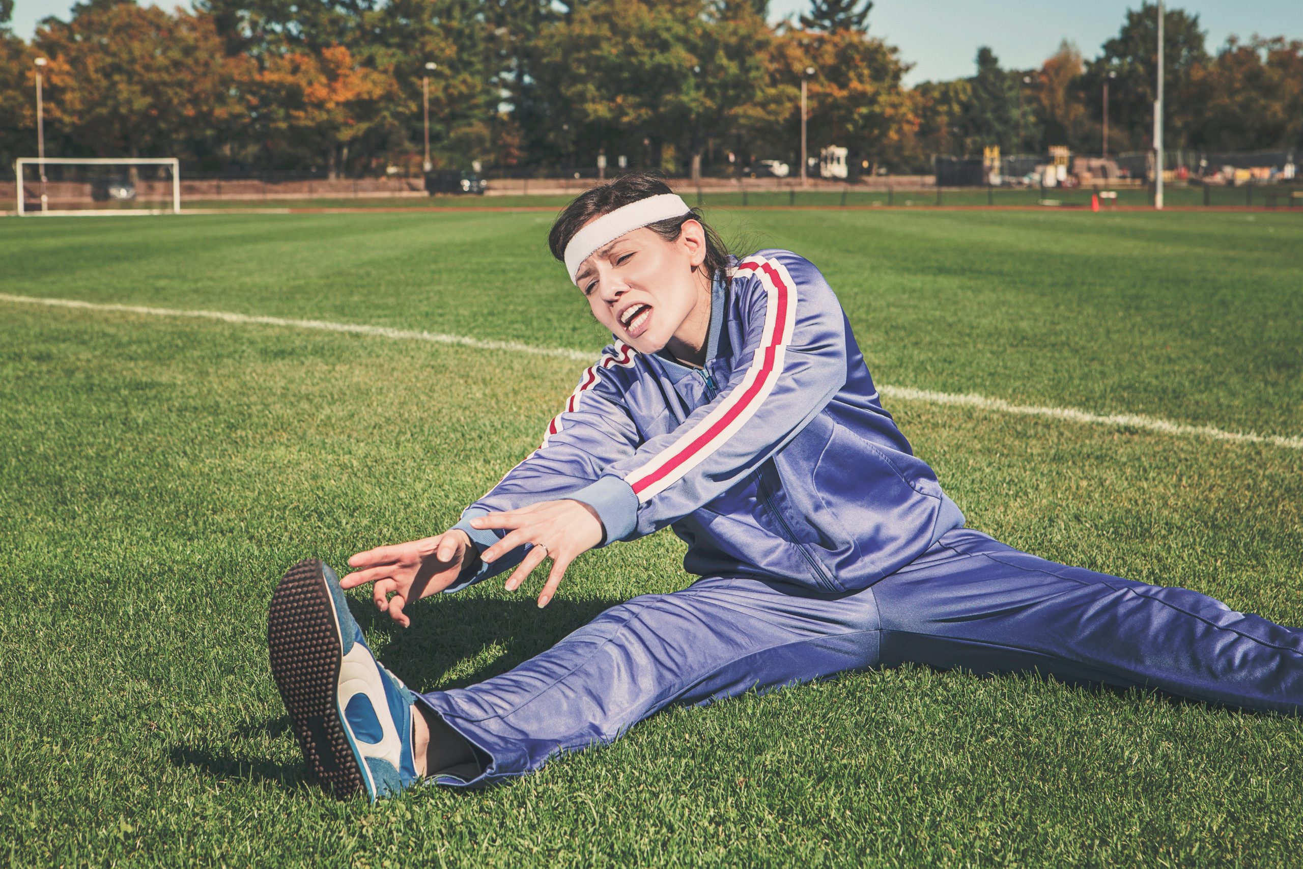 woman stretching in a field